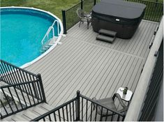 an above ground pool with decking and hot tub