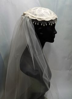 a mannequin wearing a veil and head piece