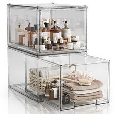 two acrylic storage containers filled with personal care items on top of each other