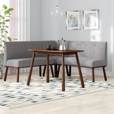 a table and bench in a room with white walls