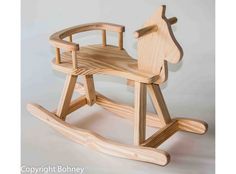 a wooden rocking horse toy on a white background