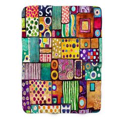 a colorful patchwork quilt with lots of different colors and patterns on the front, including dots