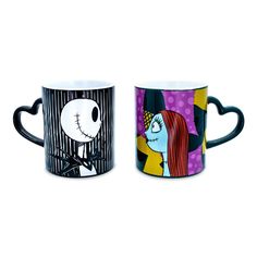 two coffee mugs with cartoon characters painted on the inside one is black and white