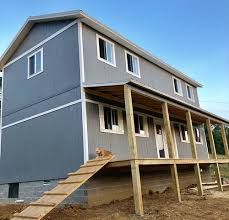 a house under construction with stairs leading up to it