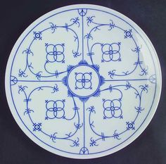 a blue and white plate with designs on it