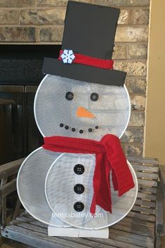 a snowman made out of mesh sitting on top of a wooden bench in front of a fireplace