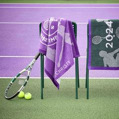 two tennis rackets and towels on a court