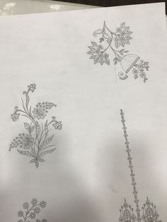 an image of some drawings on paper with flowers and vines in it, as well as other designs