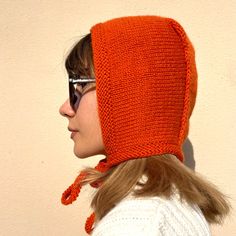 a woman wearing an orange knitted hat