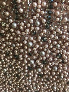 pearls and sequins are seen on the back of a purse in this close up photo