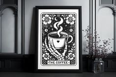 the coffee tarot card is displayed on a table next to a vase with flowers