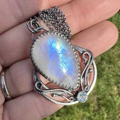 "This beautiful, detailed moon pendant has been handcrafted from 935 silver and sterling silver. The main stone is a stunning rainbow moonstone, with is paired Aquamarine. The pendant was carefully oxidized and polished to give it an antique look. Pendant: Length and width: 1.88\"x1.37\" inches (48x35mm) Materials: 925 sterling silver, 935 silver Gemstones: Rainbow Moonstone 31x20mm - 31.45ct, Aquamarine 5mm Necklace: Length: 18\"+1.18\", 20\"+1.18\" or 24\"+1.18\"  Extension chain: 1.37\"  Mate Artisan Silver Necklace With Moon Phase, Artisan Silver Necklace With Moon Phase Detail, Silver Engraved Moonstone Necklace, Artisan Silver Jewelry With Moon Phase, Engraved Silver Moonstone Necklace, Oxidized Moonstone Pendant Necklace, Moonstone Pendant Necklace With Oxidized Finish, Oxidized Moonstone Jewelry Gift, Silver Oxidized Moonstone Necklace