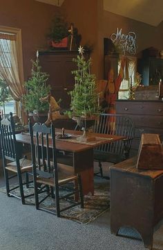 a dining room filled with lots of furniture and christmas trees on top of it's tables