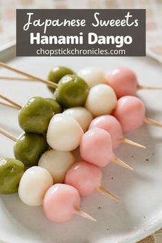 several skewered food items are arranged on a white plate with green and pink toppings