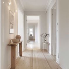 The use of light wood flooring in this Scandinavian hallway adds warmth and natural texture to the space, while maintaining a fresh, contemporary look Hallway Inspiration, Hallway Designs