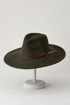 Our Marin wide-brimmed hat will never go out of style. From its iconic teardrop, pinch-front crown to its corded hatband accented with a feathered flourish, the Marin was designed to make a statement. With its prominent 22" circumference, Marin strikes an unmistakable silhouette while shading you from the sun. An inner drawstring sweatband adjusts for the perfect fit, making this any season's must-have accessory. Safari Hats, Cossack Hat, Concealed Carry Bags, Business Travel Bag, Outback Hat, Safari Hat, Brimmed Hat, Sheepskin Slippers, Western Hats