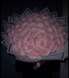 a bouquet of pink roses is wrapped in clear cellophane and ready to be delivered