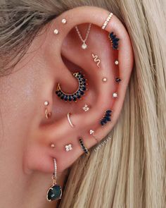 a woman wearing ear piercings with different designs