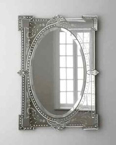 a mirror that is on the wall in front of a white wall with a window