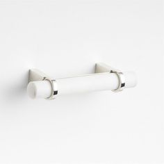 a white wall mounted toilet paper holder with two rolls on each side and one roll down the middle