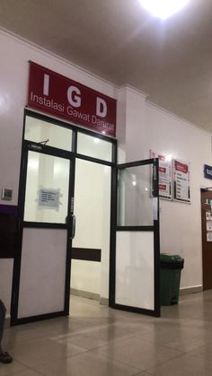 the inside of a building with two doors and signs on the wall above them that say igb