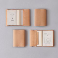 four different types of leather folders on a gray surface with red and white paper