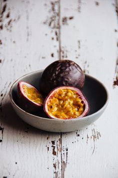 a bowl filled with food sitting on top of a white table next to an open fruit