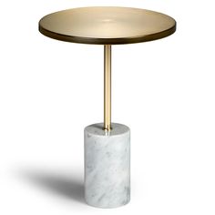 a white marble table with a gold metal base