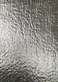 an abstract silver background with wavy lines and drops of water on the bottom right corner