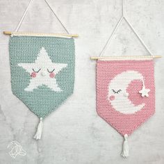 two crocheted wall hangings with stars and moon on them, one is pink and the other is green