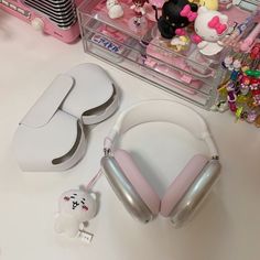 the headphones are laying on the table next to other toys and accessories, including a teddy bear