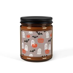 a jar filled with halloween candles on top of a table