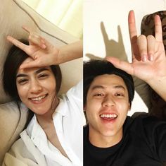 two people making the peace sign with their hands