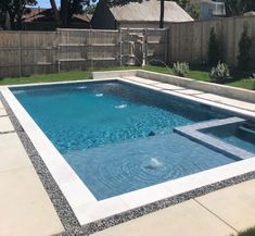 an empty swimming pool in the middle of a backyard