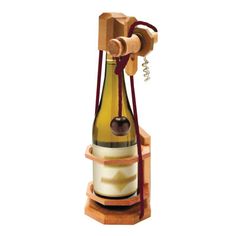 a wooden wine bottle holder with an apple hanging from it's top, on a white background