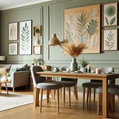 a dining room table with chairs and pictures on the wall above it, along with two couches