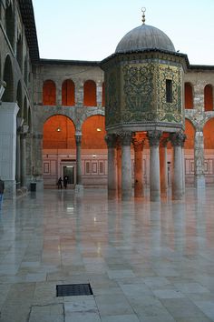 the inside of an old building with columns and a dome