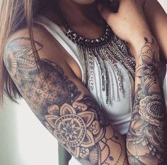 a woman with tattoos on her arms posing for the camera