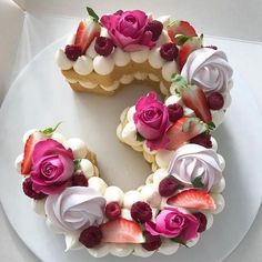 a white plate topped with a cake covered in flowers