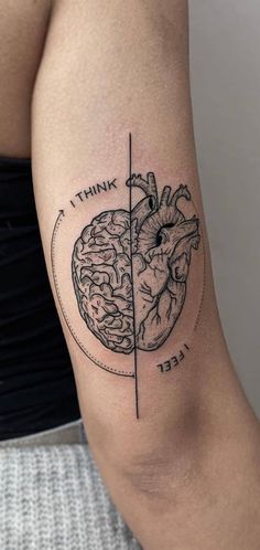 a woman's arm with a heart and brain tattoo on it