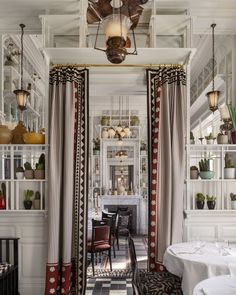 the dining room is decorated in black, white and red with lots of hanging lights