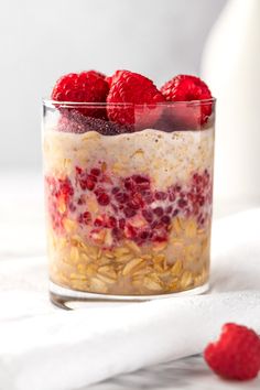 raspberry and oatmeal breakfast in a jar with fresh berries on top