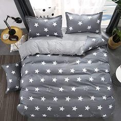 a bed with grey and white stars on it