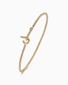 A Vibe signature, this slim version of the St. John Hook Bracelet is fashioned in a 14K solid gold intertwined rope-inspired band with a "J" hook clasp to honor the island of St. John. Featuring a tiny replica of the St. John petroglyph, solo or stacked, it is sure to be a favorite piece. In the Caribbean tradition, wear your hook facing in to keep love close to your heart, and facing out if you are open to a new love in your life. Wear this piece on its own or stack it with other bracelets for Luxury Classic Bracelet With Hooks And Links, Classic Gold Oval Link Bracelet With Hooks, Hook Bracelet Caribbean, Everyday Yellow Gold Rope Chain Bracelet, Classic Gold Rope Chain Bracelet, Solid Gold Bracelet, Hook Bracelet, Solid Gold Band, Island Vibes