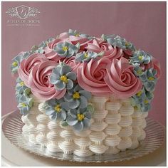 a white cake with pink and blue flowers on top