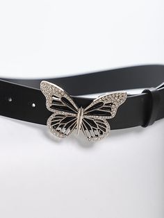 a black belt with a butterfly buckle on the front and side of it, sitting on top of a white surface