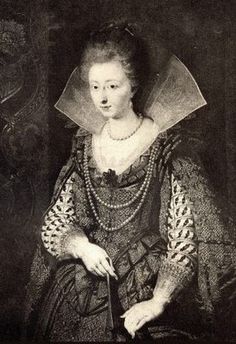 an old black and white photo of a woman in a dress with a veil on her head