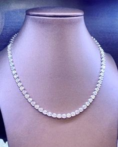 She'll never tire of wearing this classic and sophisticated diamond tennis necklace. Stunning in 18K solid white gold, this breathtaking line of shimmering round diamonds. So elegant, this 17.0-inch diamond necklace will take her breath away. Radiant with 8.87 cts. t.w. of diamonds and buffed to a brilliant luster, this glamorous keepsake secures with a box clasp. The setting design make the diamonds look much bigger than they are. When worn, the diamonds look like 1/2 carat each. 2/3 diamonds, Diamond Necklace That You Can Change To A White Or Gold Chain, 2 Line Diamond Necklace, Anniversary Tennis Necklace In Diamond White With Brilliant Cut, Round Single Strand Tennis Necklace For Anniversary, Classic Platinum Tennis Necklace With Brilliant Cut, Diamond Wedding Tennis Necklace, White Tennis Necklace With Moissanite In Prong Setting, White Moissanite Tennis Necklace For Anniversary, White Platinum Tennis Necklace With Single Cut Diamonds