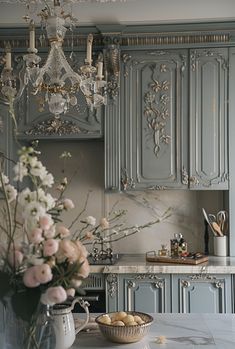 a vase with flowers in it sitting on a kitchen counter next to a bowl of food