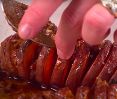 a person is cutting up some meat with a knife